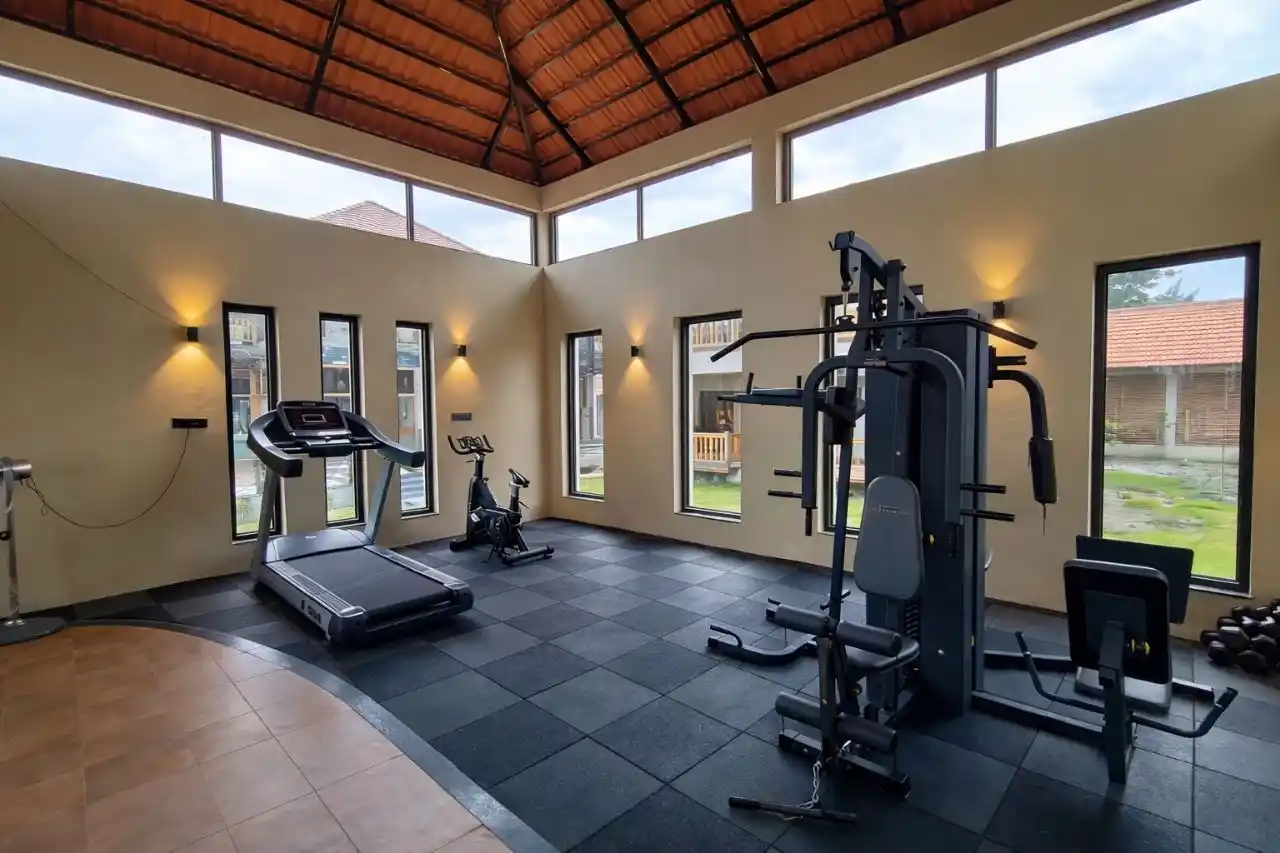 Modern gym facility at Hotel Sonar Bangla Sundarban with fitness equipment and luxury amenities.