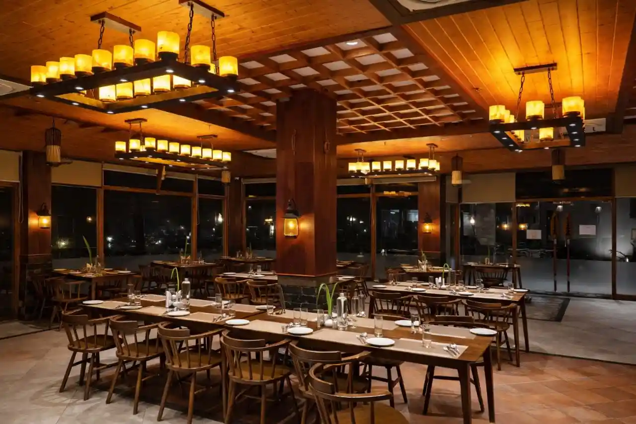 Luxury dining restaurant at Hotel Sonar Bangla Sundarban with elegant lighting and seating area.