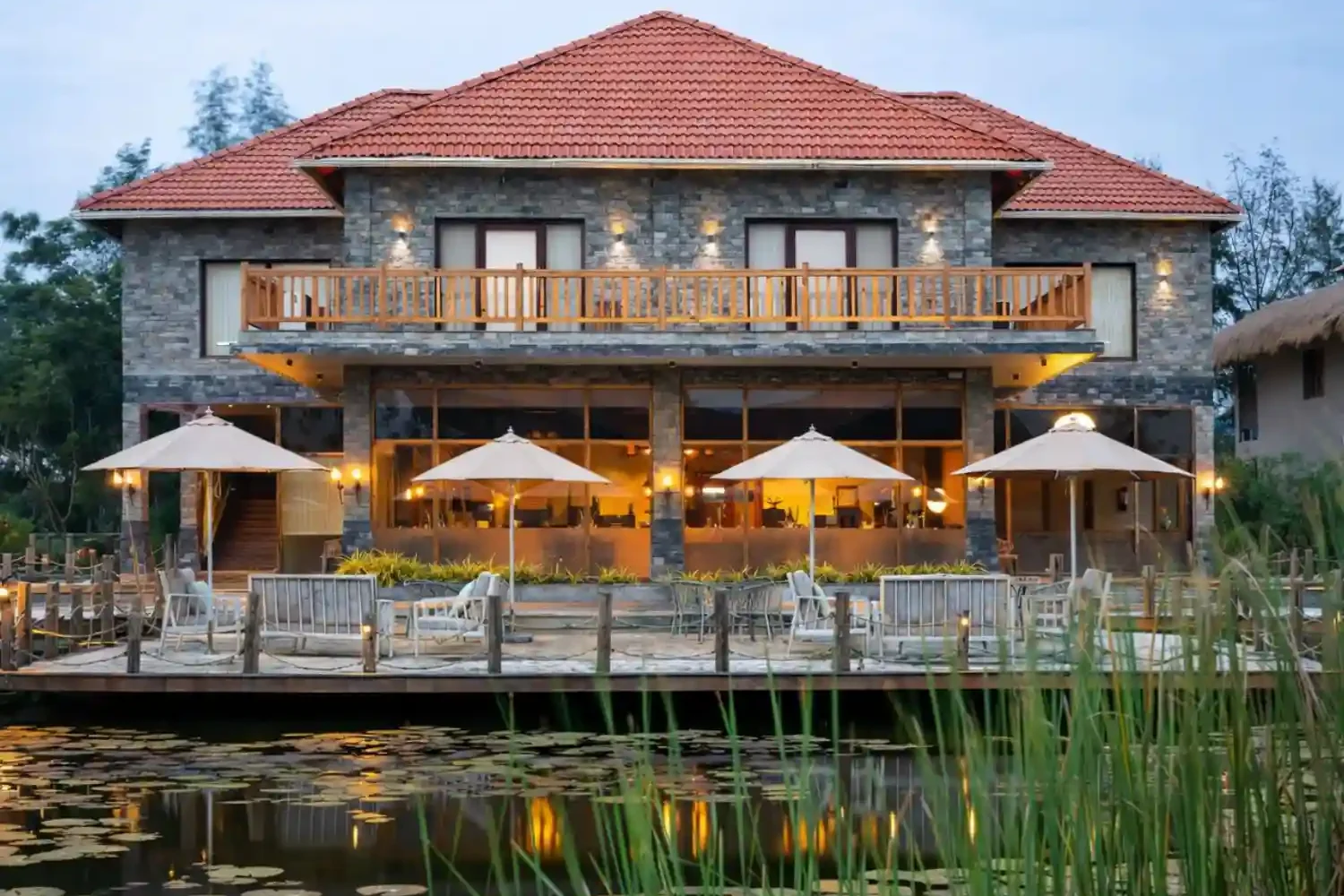 Hotel Sonar Bangla luxury resort in Sundarbans showing swimming pool, main building, and premium seating area.