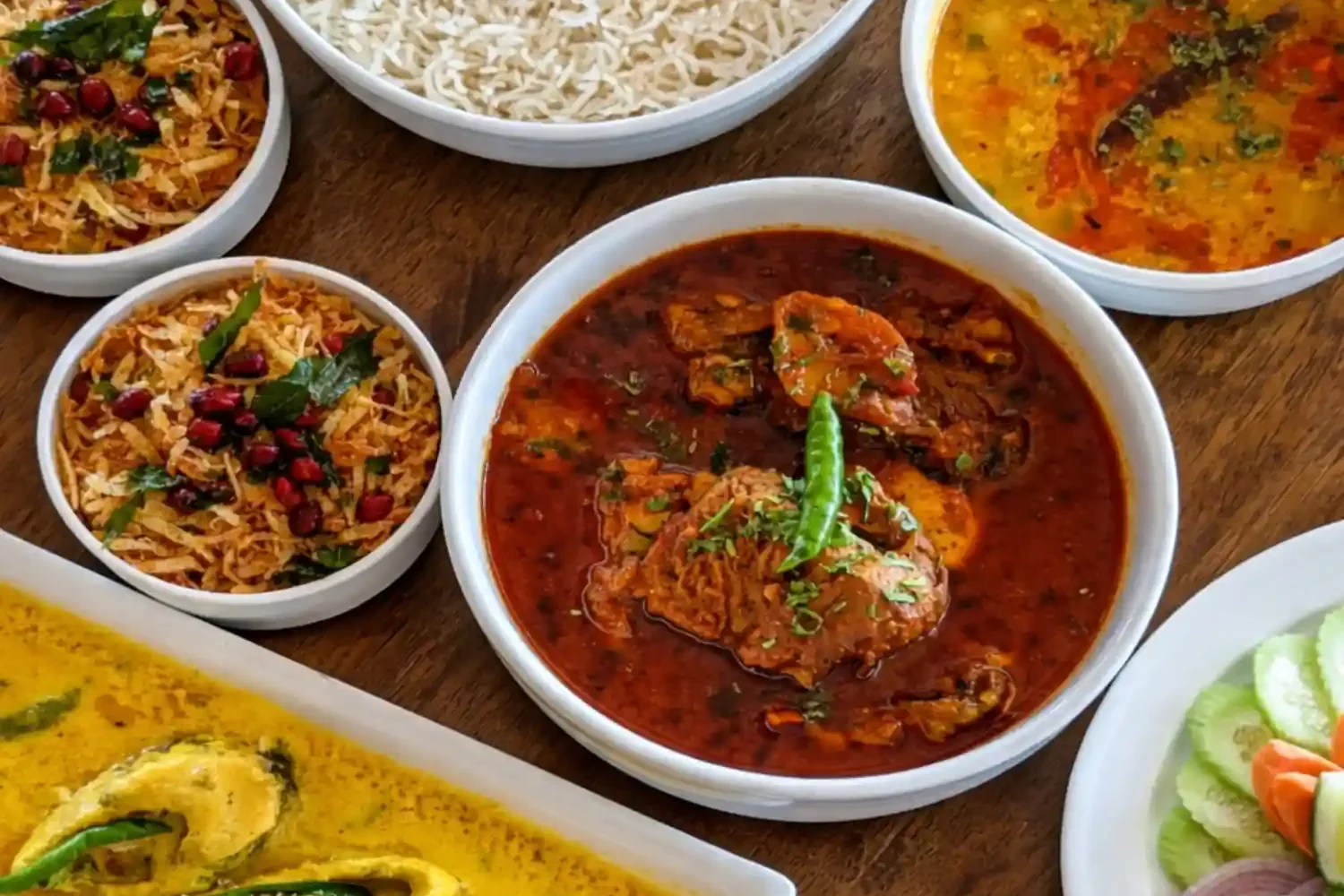 Traditional Bengali food meal with rice, fish curry, chicken curry and dal served during Sundarban tour.